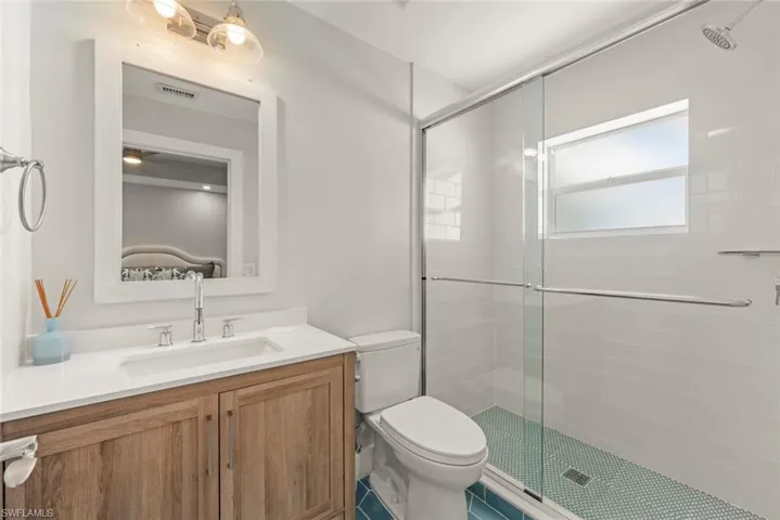 Bathroom with vanity and a stall shower