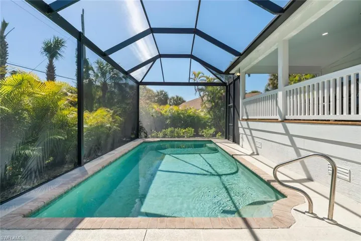 Swimming pool featuring a lanai and a sunroom