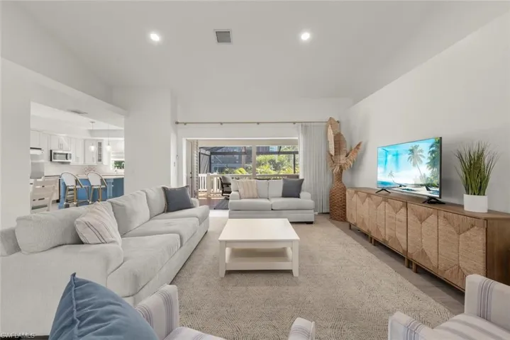 Living room with wood finished floors and recessed lighting