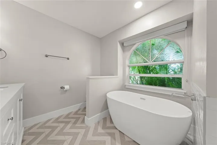 Full bath featuring a freestanding tub and vanity