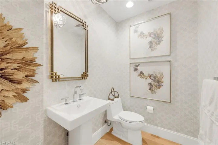 The powder room is perfectly located in the hallway just behind the kitchen.