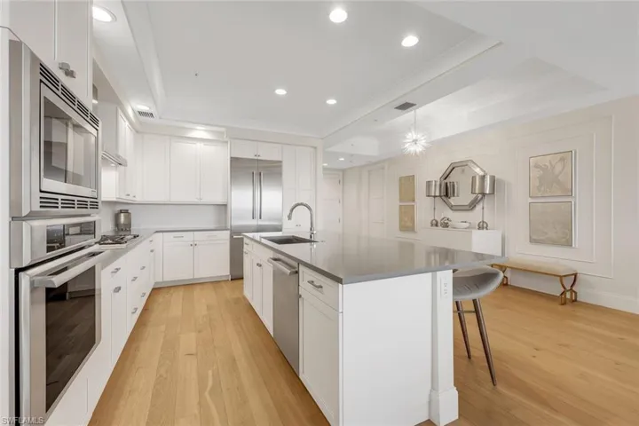 The large island is perfect for friends to gather around and partake in small bites and a favorite cocktail.