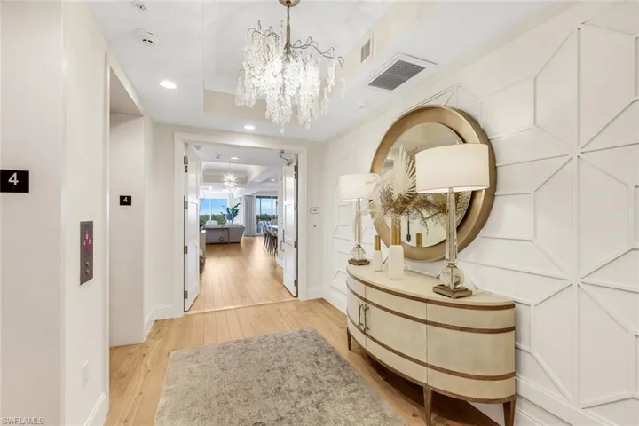 Private elevator lobby with featuring gorgeous chandelier is sure to impress guests!