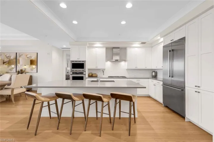 Beautiful white cabinetry and tray ceilings complement this space.
