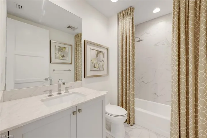 Ensuite guest bathroom feature a tub.