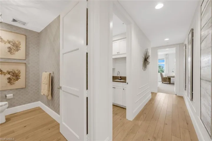 Powder room and guest suites are privately tucked away on the east side of the home.