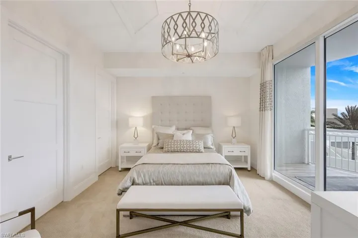 Guest bedroom, located on east side of home, with open balcony and ensuite bathroom.