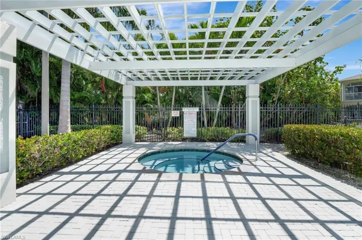 View of pool featuring a pergola, fence, a hot tub, and a patio