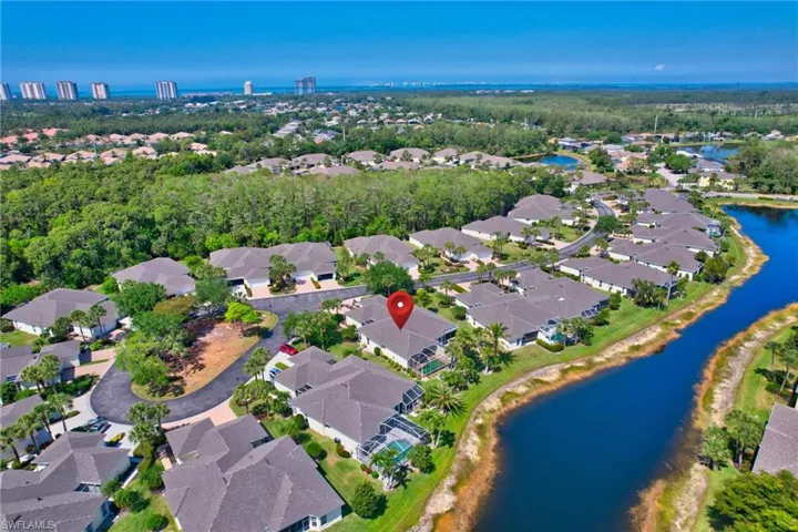 Birds eye view of property with a water view and a residential view