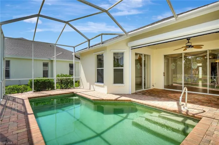 Pool featuring a lanai, a patio area, and a ceiling fan