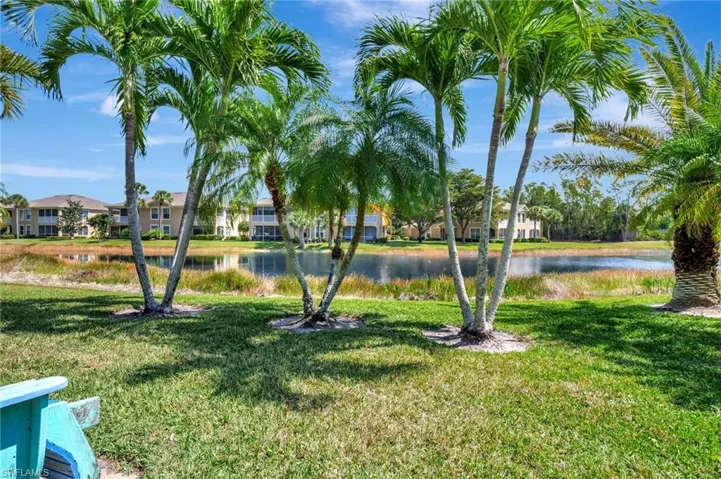 View of yard with a residential view and a water view