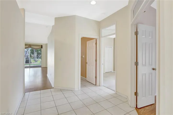 Spare room featuring light tile patterned floors and baseboards