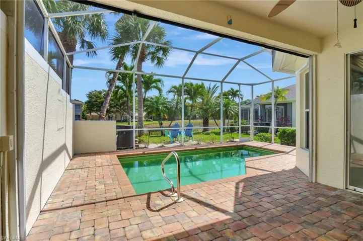 Outdoor pool with a ceiling fan, a lanai, and a patio