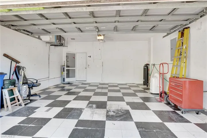 Garage with electric panel and a garage door opener