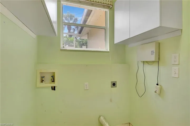 Laundry room featuring hookup for a washing machine, cabinet space, and electric dryer hookup