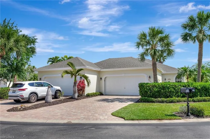 Ranch-style home with driveway, stucco siding, an attached garage, and roof with shingles