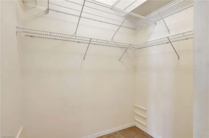 Walk in closet featuring light tile patterned flooring
