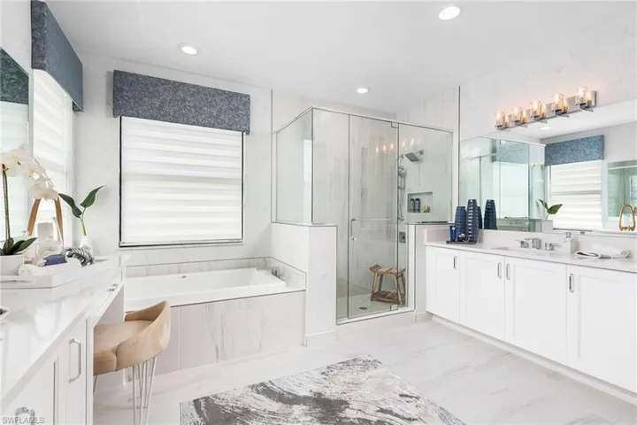 Bathroom featuring vanity and shower with separate bathtub