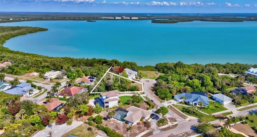 Aerial view of residential area featuring a large body of water