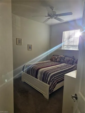 Carpeted bedroom with ceiling fan