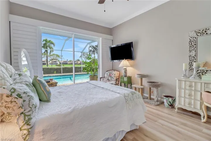 Bedroom with access to outside, ceiling fan, ornamental molding, and light wood-type flooring