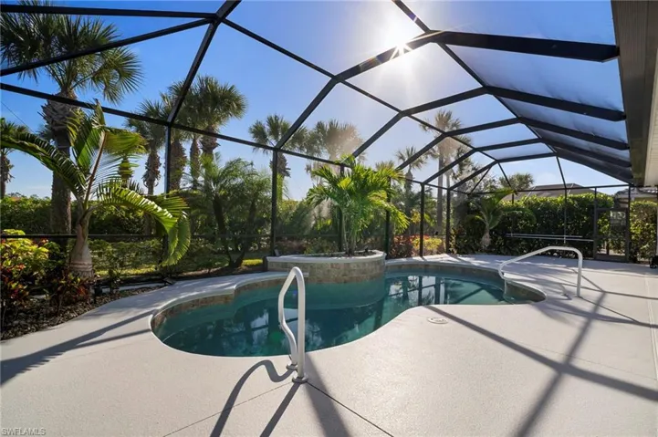 Swimming pool featuring a lanai, a sunroom, and a patio