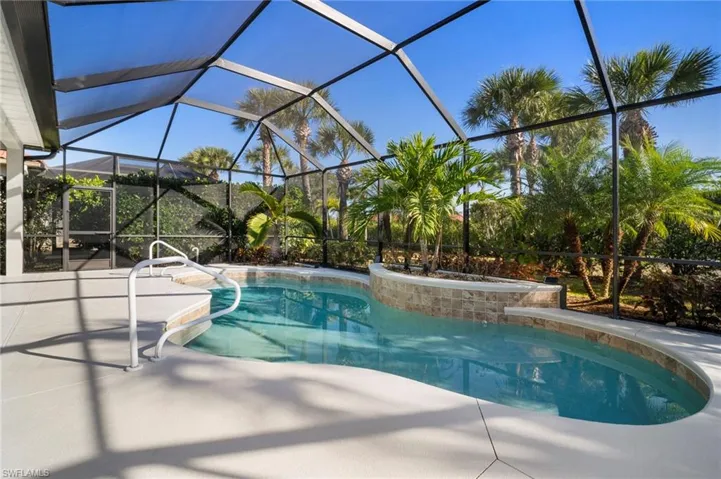 Swimming pool with a sunroom, glass enclosure, and a patio