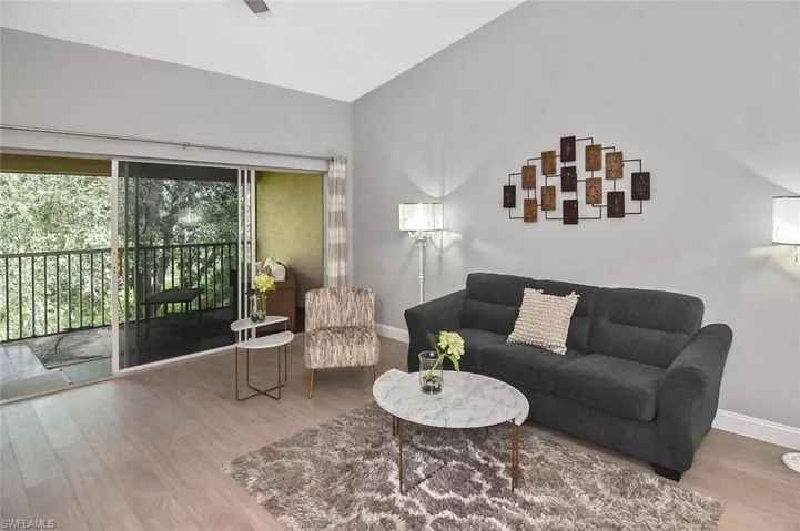 Living area with wood finished floors and baseboards