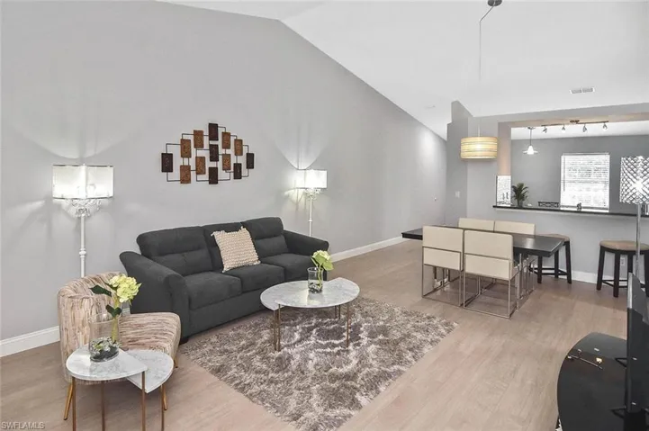 Living room featuring vaulted ceiling and wood finished floors