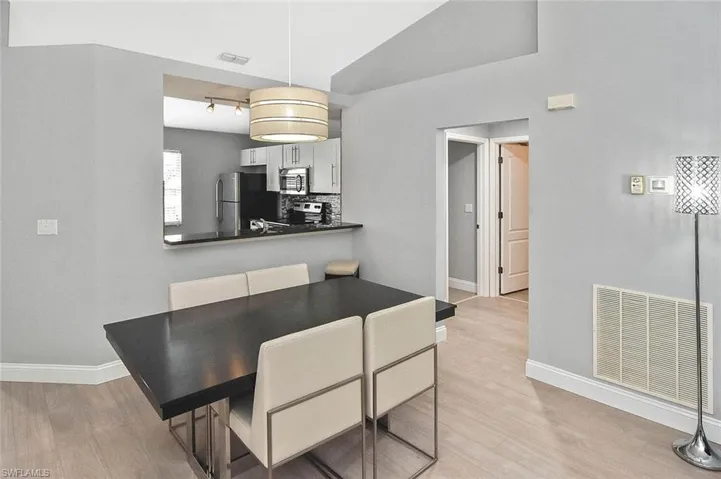 Dining space with light wood-type flooring and baseboards