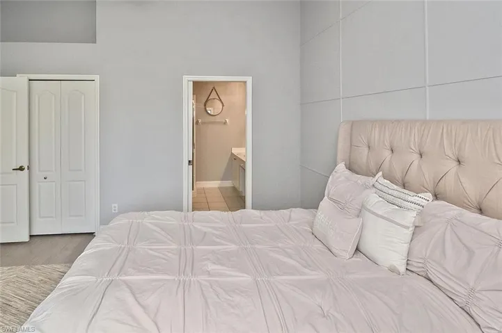 Bedroom featuring connected bathroom and light wood-style floors