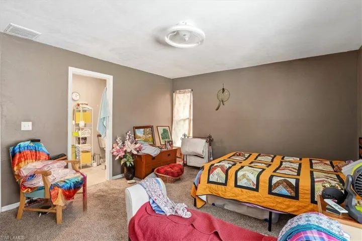 Bedroom featuring carpet flooring and baseboards
