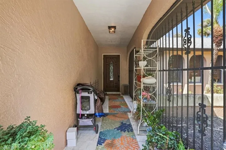 Doorway to property with stucco siding