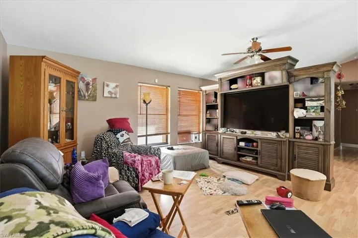 Living area featuring light wood-style flooring and a ceiling fan