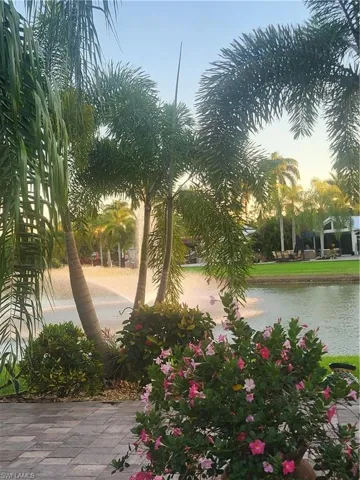 Yard at dusk featuring a water view