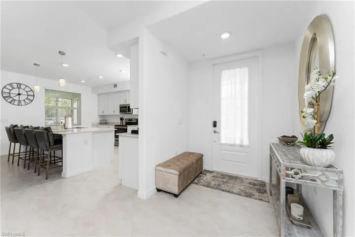 Foyer with recessed lighting and light tile patterned flooring