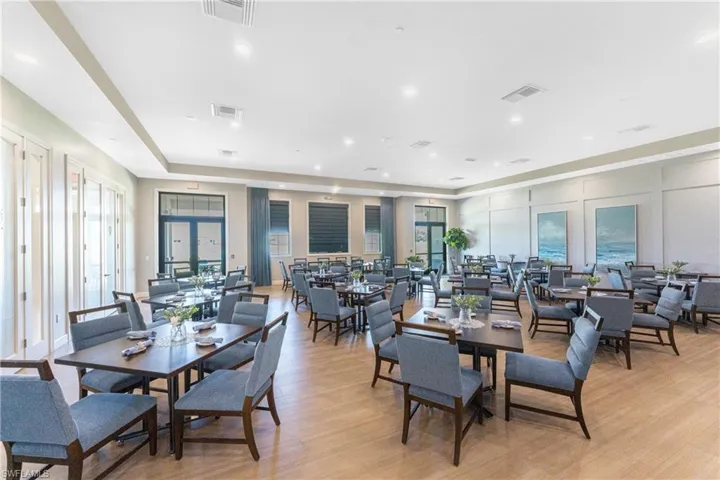 Dining room featuring a decorative wall, light wood-style floors, healthy amount of natural light, and recessed lighting