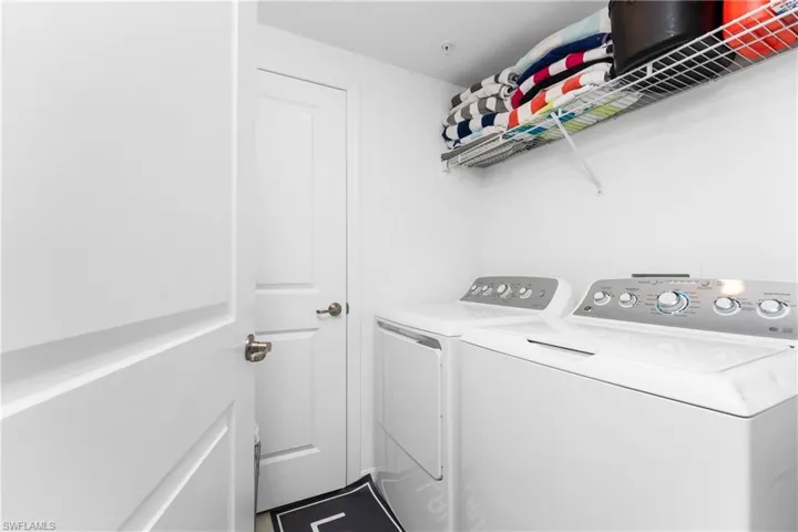 Laundry room featuring washing machine and clothes dryer