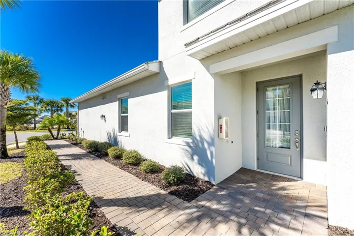 View of exterior entry with stucco siding
