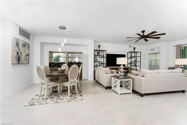 Dining area featuring ceiling fan and baseboards