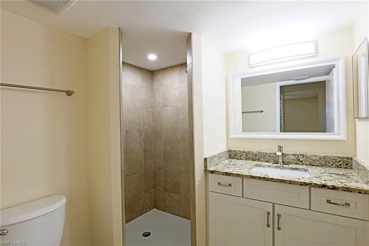 Bathroom featuring a stall shower and vanity