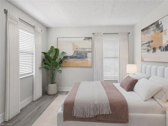 Bedroom featuring a textured ceiling and wood finished floors