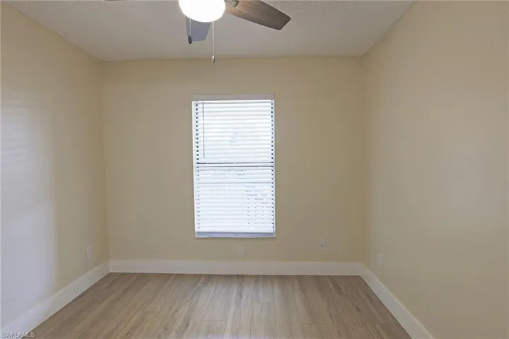Unfurnished room with light wood-style flooring and a ceiling fan