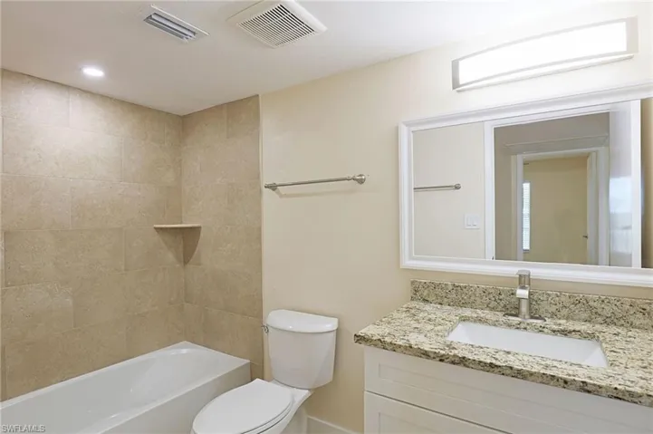 Full bath featuring shower / tub combination, vanity, and recessed lighting