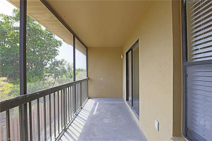 Balcony featuring a sunroom