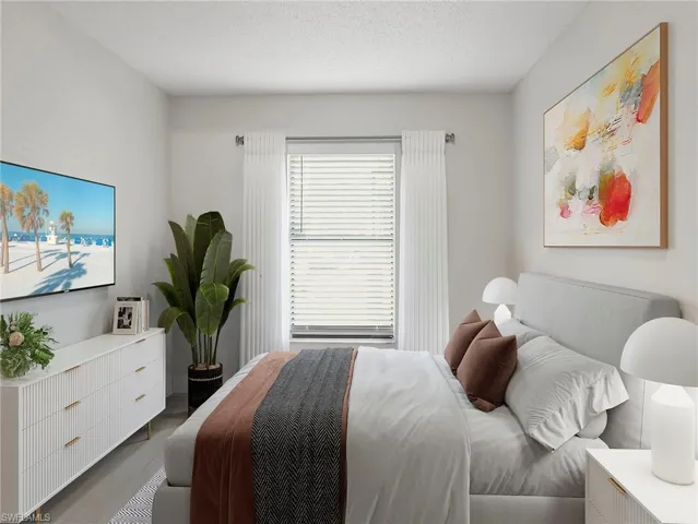 Bedroom with a textured ceiling and wood finished floors