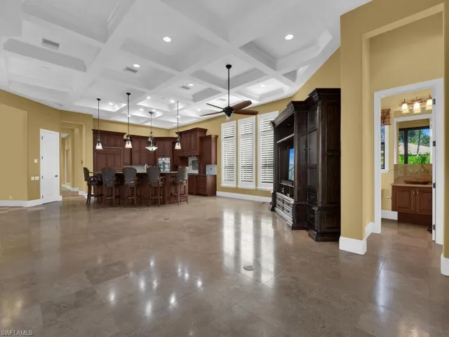 Living room with coffered ceiling, ceiling fan, beam ceiling, and recessed lighting