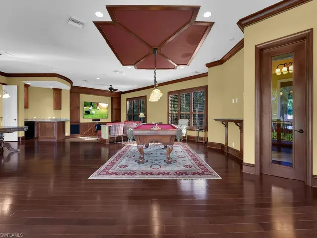 Game room featuring billiards table, ornamental molding, dark wood-type flooring, and recessed lighting