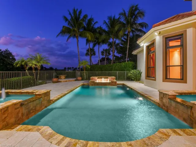 View of pool with a pool with connected hot tub, a patio, and a fenced backyard