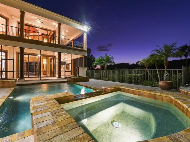 View of swimming pool featuring an in-ground hot tub, a patio, and a balcony